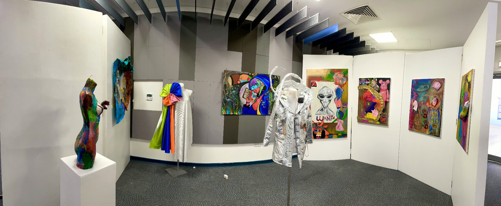Full installation view — paintings, sculpture and wearable pieces